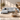 Light grey left sectional sofa with chaise, upholstered cushions and track arms