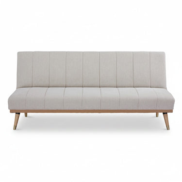 Light grey sofa bed with vertical channel tufting and wooden tapered legs