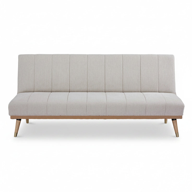 Light grey sofa bed with vertical channel tufting and wooden tapered legs
