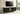 Dark wood TV cabinet with fluted sliding doors, open center shelves, and slim metal legs
