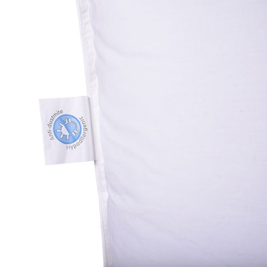 White travel pillow fabric detail with care tag