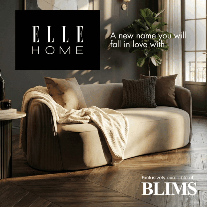 Modern living room with a beige sofa, decorative pillows, and a plant, featuring the Elle Home branding.