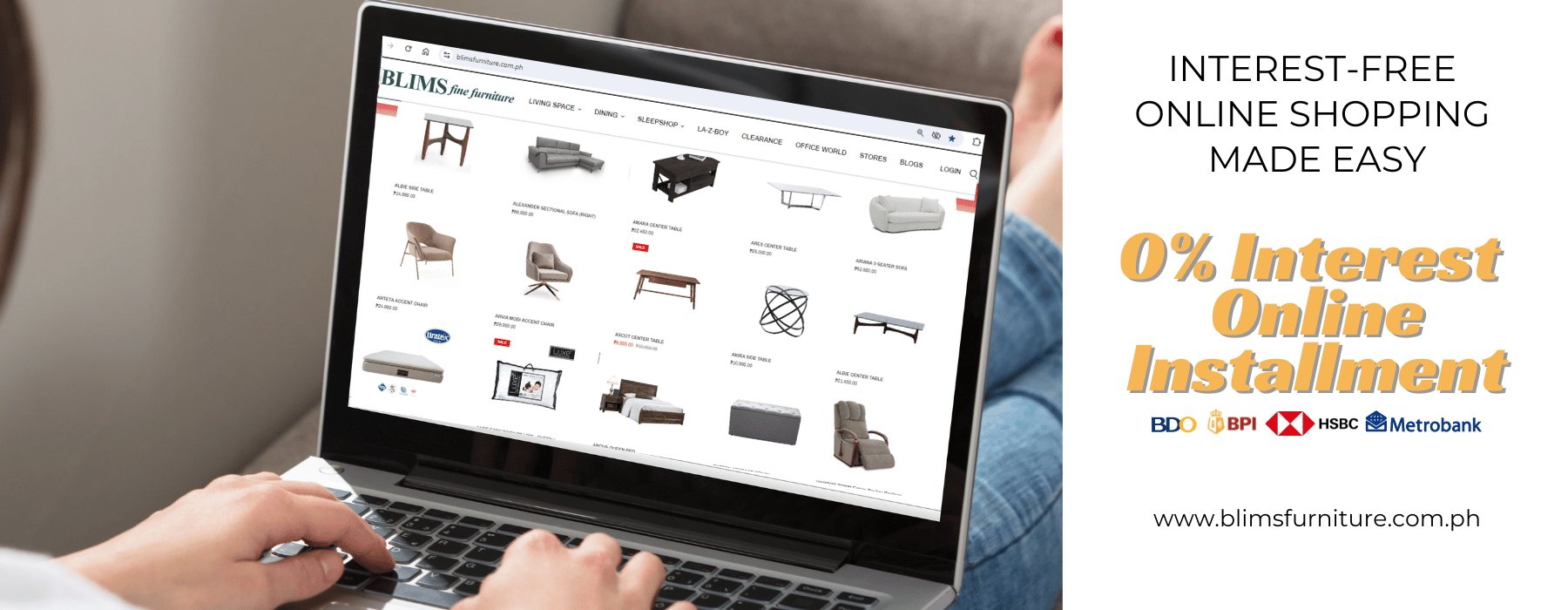 Person using a laptop on a sofa with an online furniture shopping website displayed.