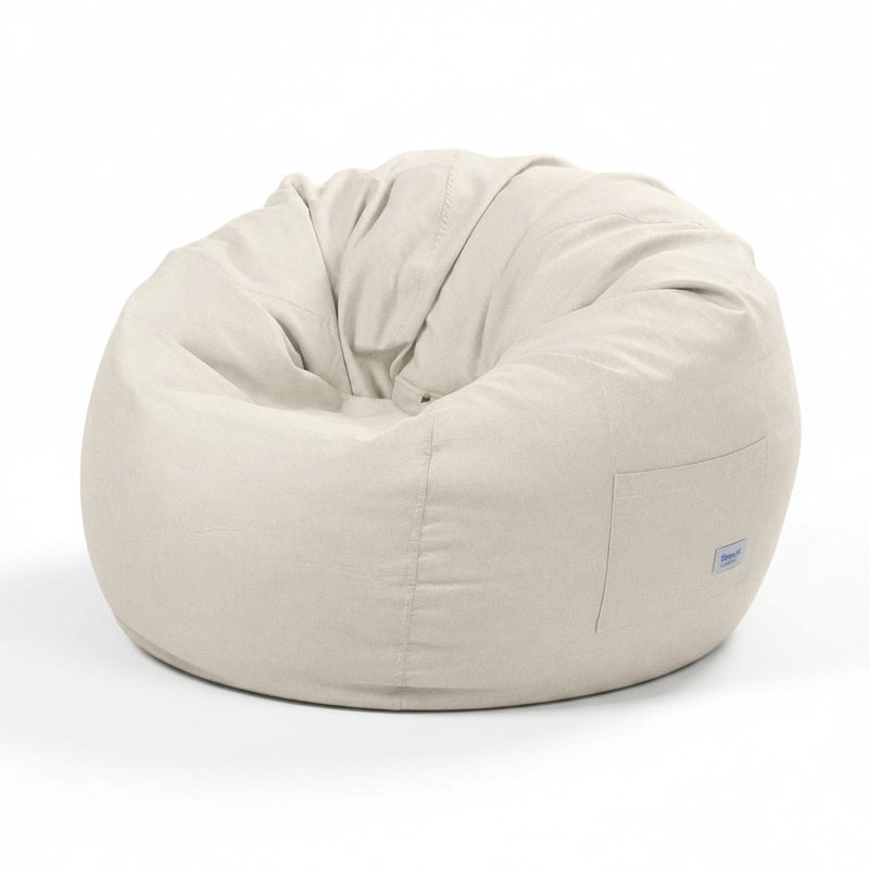 Cream fabric bean bag with curved top seam and side pocket panel, includes small tag