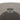 Metallic center finial detail on a round glass top of a side table