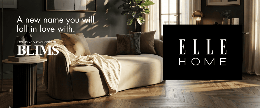 Modern living room with a sofa, coffee table, and decorative elements with 'ELLE HOME' branding.