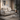 Light grey 2-seater sofa with padded arms and cushioned backrest
