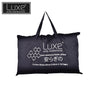 Black contour memory foam pillow in printed tote-style bag with handles