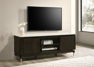 Dark wood TV cabinet with fluted sliding doors, open center shelves, and slim metal legs