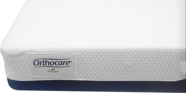 White mattress cover with OrthoCare label patch and navy side trim